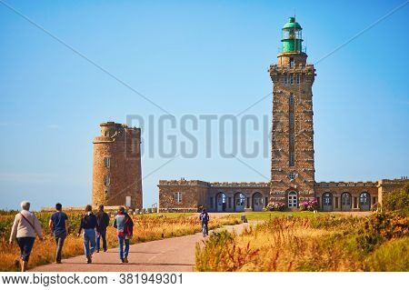 People Heading To The Lighthouse On Cape Frehel, One Of The Most Popular Tourist Destinations In Bri