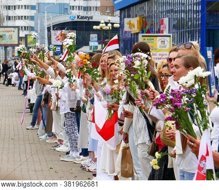 Minsk, Belarus - August 22, 2020. People Holding Flowers During Peaceful Protests. Minsk, Belarus. P