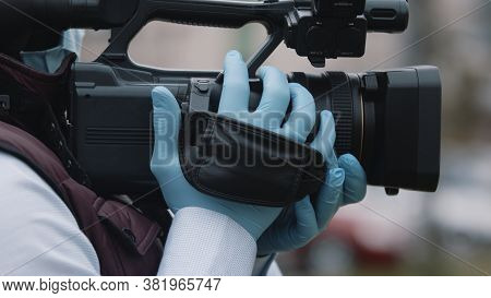 Close Up, African Black Videographer With Medikal Mask Looking Through The Viewfinder On Video Camer
