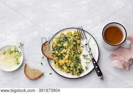 Scrumble Eggs With Kale And Cheese On A Light Gray Background, Top View. Delicious Homemade Breakfas