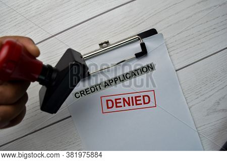 Red Handle Rubber Stamper And Credit Application - Denied Text Isolated On The Table.