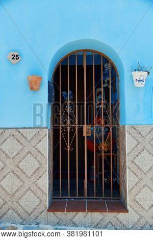 JUZCAR, SPAIN - MAY 22, 2019: Blue village of Juzcar street view in Spain.