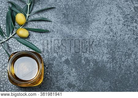 Glass Bottle Of Homemade Olive Oil And Olive Tree Branch, Raw Turkish Green Olive Seeds And Leaves O