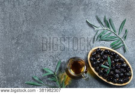 Glass Bottle Of Homemade Olive Oil And Olive Tree Branch, Raw Turkish Black Olive Seeds And Leaves O