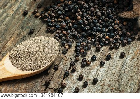 Heap Of Black Pepper And Black Pepper Powder, Milled Peppercorns On Wooden Background, Dried Spice P
