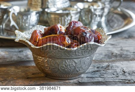 Ramadan Palm Fruit Dates In Silver Bowl And Zam Zam Water Symbolize Sacred Month For Muslims. Ramada