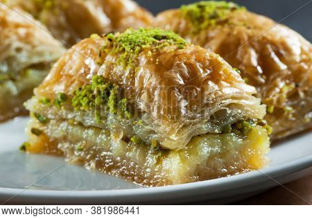 Traditional Turkish Dessert Antep Baklava With Pistachio On White Plate. Desserts Concept