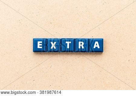 Tile Letter In Word Extra On Wood Background