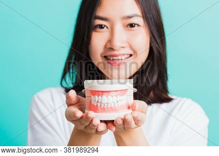 Portrait Of Asian Teen Beautiful Young Woman Smile Have Dental Braces On Teeth Laughing She Holding 