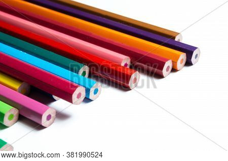 A Stack Of Multicolored Unsharpened Pencils On A White Background. Close-up.