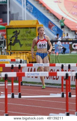 DONETSK, UKRAINE - JULY 11: Iuliia Sokolova of Russia competes in semi-final of 100 m hurdles during 8th IAAF World Youth Championships in Donetsk, Ukraine on July 11, 2013