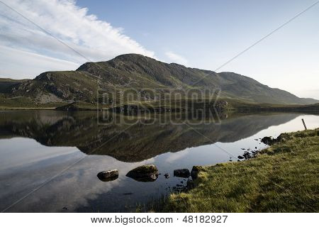 Beautiful Sunrise Mountain Landscape Reflected In Calm Lake