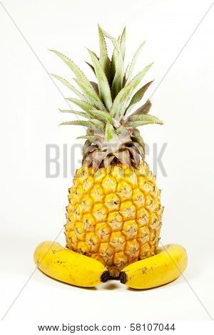 Two Ripe Yellow Bannanas And Pineapple On White