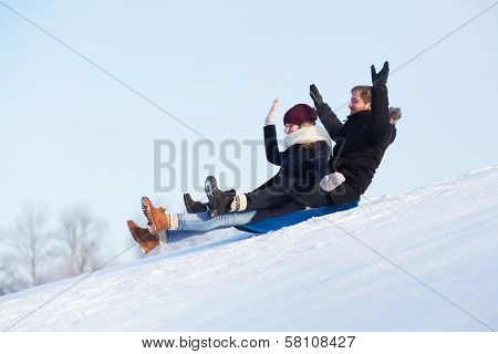 Young Happy Couple Sledging