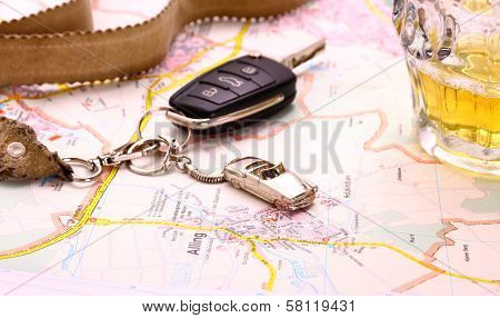 Car Key With Accident And Beer Mug On Map