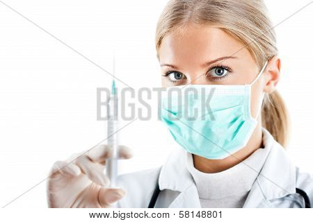 Doctor with protective mask and syringe