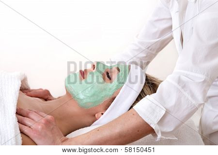 Woman Enjoys A Massage And Facial Beauty Treatment.