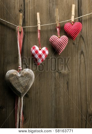 Valentine's Day wallpaper - Textile hearts hanging on the rope ascending order