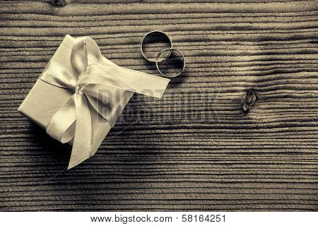 Engagement ring with gift box - wood background