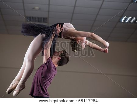 Ballet partners dancing gracefully together in the ballet studio