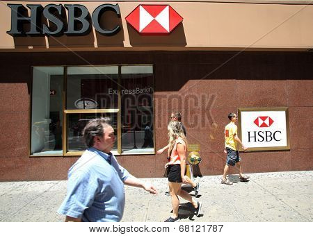 NEW YORK CITY - FRIDAY, JUNE 20, 2014:   Pedestrians walk past a HSBC bank in Manhattan on Friday, June 20, 2014. HSBC Holdings plc is a British multinational banking and financial services company