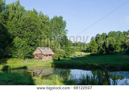 Countryside With Wooden Bathhouse And Green Nature