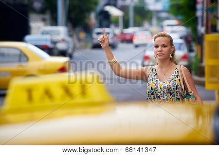 Business Woman Stopping Yellow Taxi