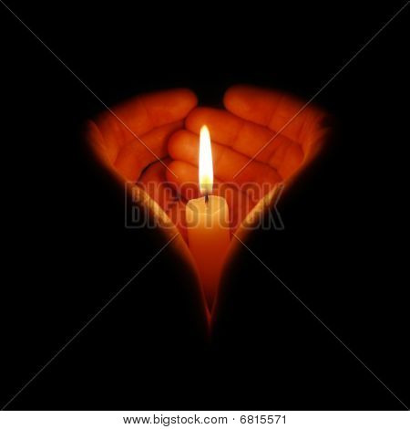 Candle fire in heart-shaped hands