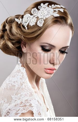 Portrait of a beautiful blonde woman in a wedding dress in the image of the bride.