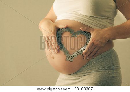 pregnant woman showing her belly