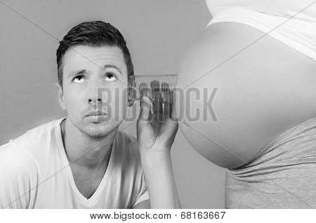 dad listening to the baby