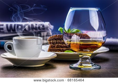 Brandy,coffee,cake and newspaper