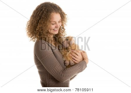 Girl holds stuffed toy sheep