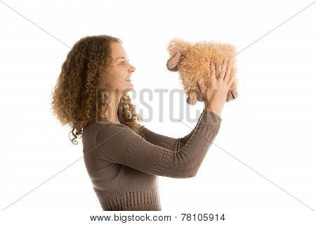 Girl plays with stuffed toy sheep