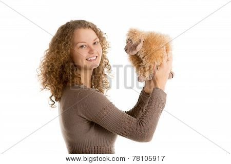 Girl plays with stuffed toy sheep