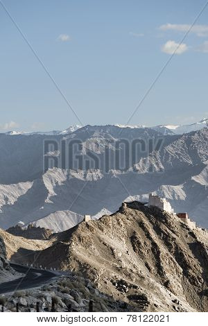 Ancient Casttle On Cliff Among High Mountains And Bending Road