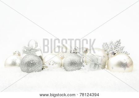 Silver Christmas Decoration On Snow In Line