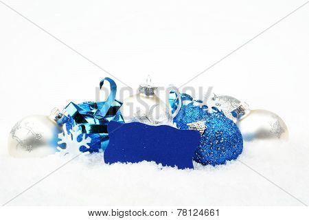 Silver And Blue Christmas Decoration On Snow With Wishes Card