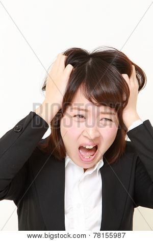 studio portrait of demented businesswoman on white background