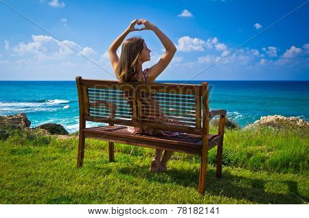 Young woman showing hands heart