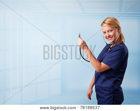 Pretty young nurse in hospital listening to empty copy space with sthetoscope