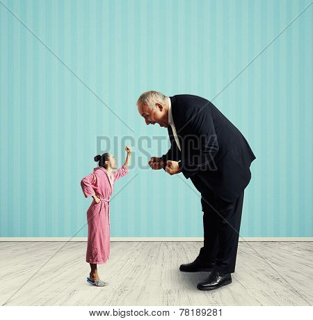 emotional senior man screaming at small woman