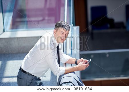 business man using phone at modern office space
