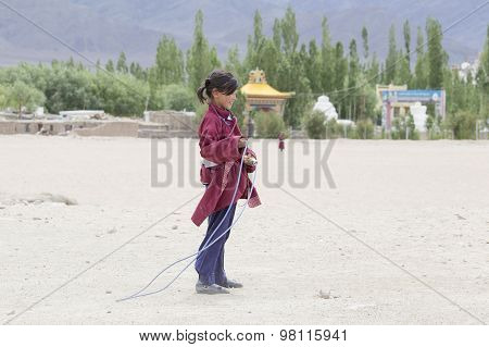 Tibetan Girl Jumping On A Skipping Rope In Druk White Lotus School. Ladakh, India