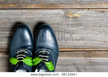italian leather shoes concept: boots laced with spaghetti and basil leaf as bow