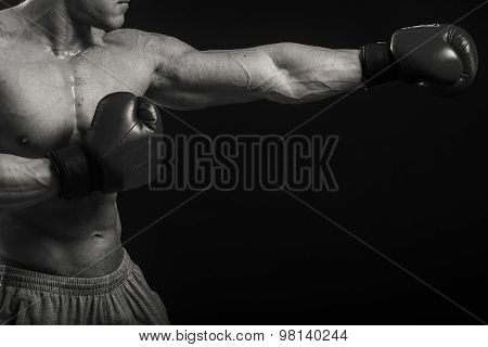 Strong boxer on a black background.