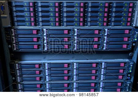 Rack of webserver harddisks in datacenter showing internet traffic