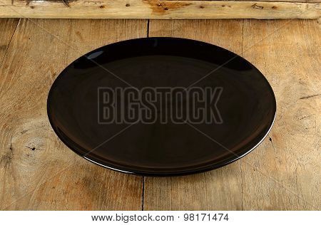 Empth Black Plate On The Wooden Background