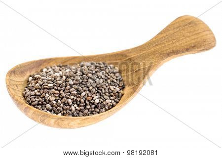 chia seeds on  a small wooden tablespoon isolated on white, selective focus