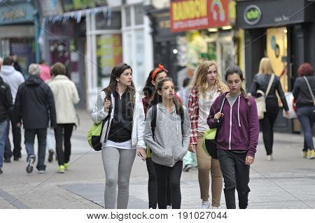 Galway Ireland July 2017 Group Of Erasmus Students Walking down Shop Street